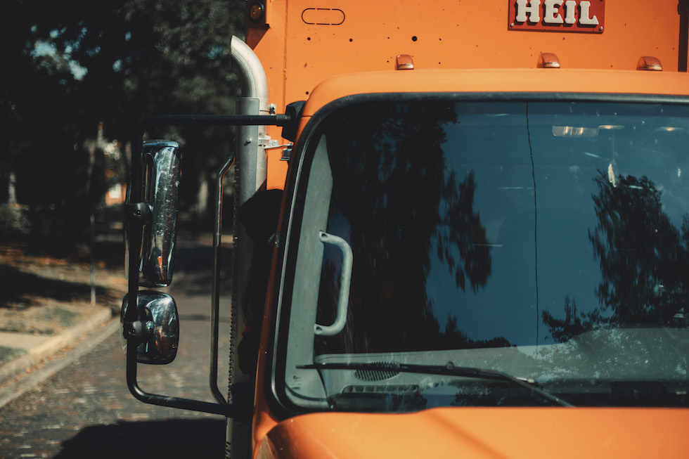 orange garbage truck front