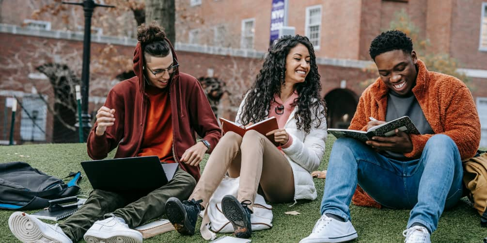 College Students Sitting on Grass