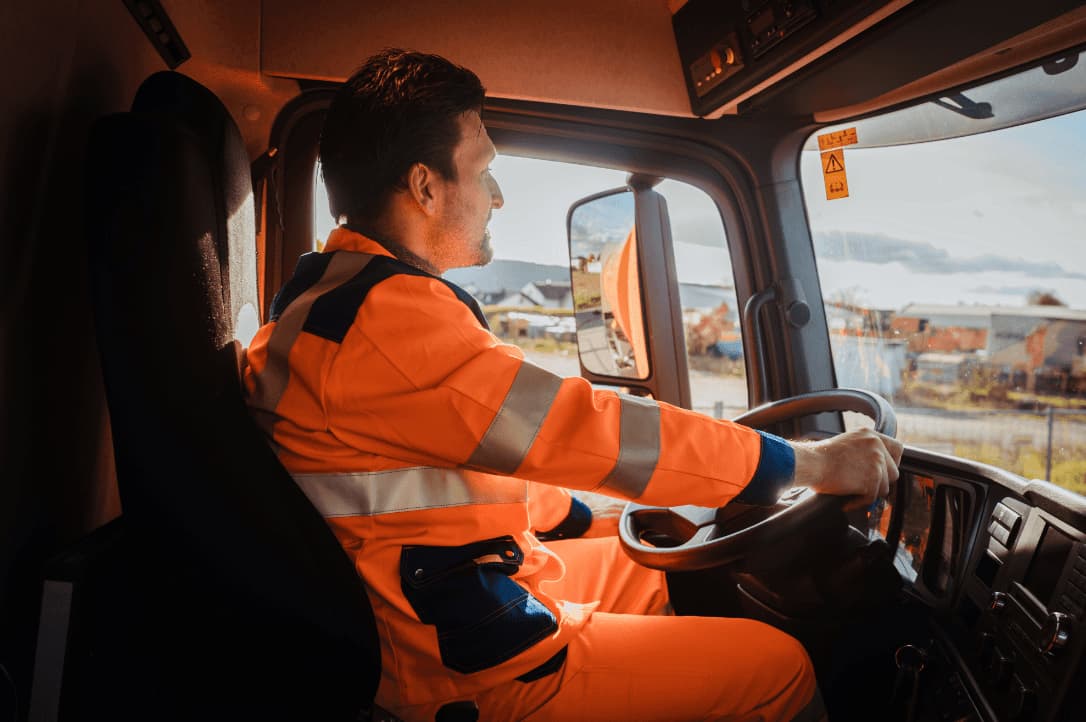 Solid waste worker driving a waste truck