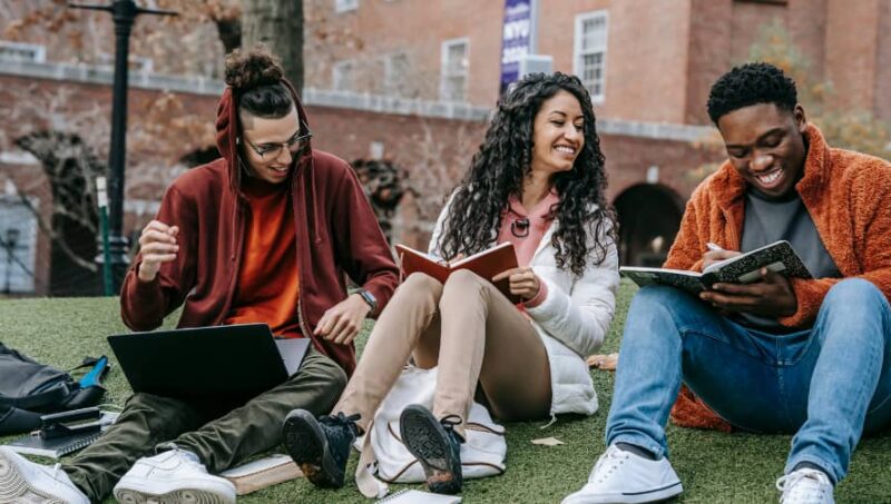 College Students Sitting on Grass