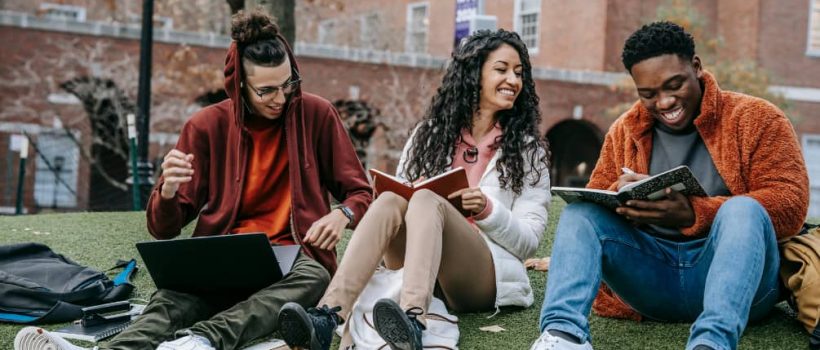 College Students Sitting on Grass