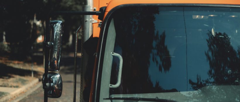 orange garbage truck front