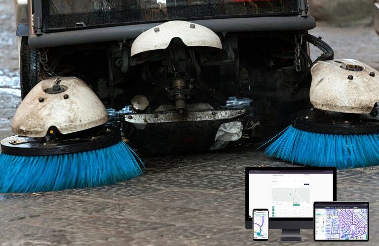 Street sweeper vehicle cleaning a city roadway with digital route tracking and performance analytics overlay.