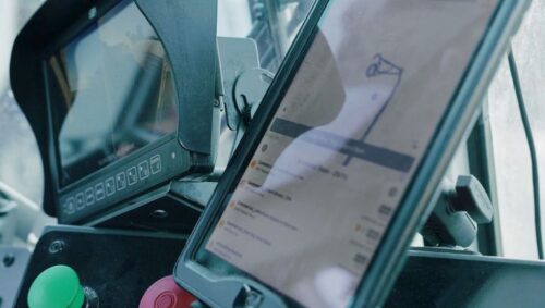 Fleet trucks and dashboards showing waste hauling service analytics and real-time route performance.