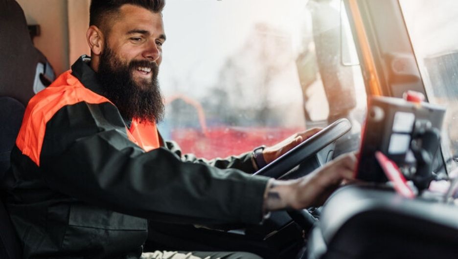Waste truck driver using in-cab navigation