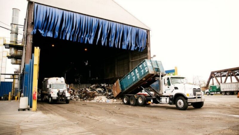 Truck dumping garbage at recycling plant