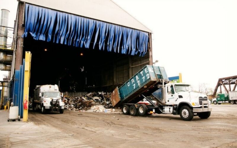 Truck dumping garbage at recycling plant